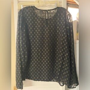 Black and gold blouse with circle detail.